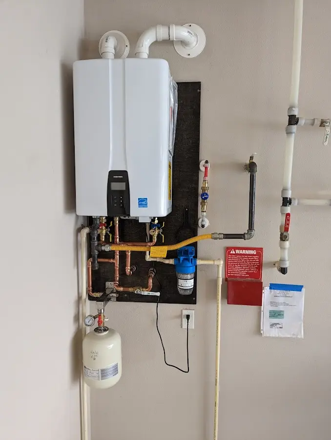 Professional plumber installing copper piping in a North Caldwell home